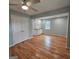 A bedroom with hardwood floors, built-in cabinets, a closet, and a window at 487 Eastside Dr, Dacula, GA 30019