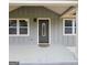 A gray house with a green front door, white trim, and manicured landscaping at 487 Eastside Dr, Dacula, GA 30019