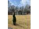Inviting single-story home with fresh grey siding, a well-maintained lawn, and mature trees at 487 Eastside Dr, Dacula, GA 30019