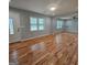 Bright living room showcasing newly refinished wood floors and fresh paint at 487 Eastside Dr, Dacula, GA 30019