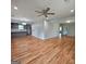 Spacious living area leads to a modern kitchen with gray cabinets and hardwood floors at 487 Eastside Dr, Dacula, GA 30019
