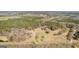 Aerial showcases the extensive property with a house, wooded areas, and road access at 461 Old Jackson Rd, Mcdonough, GA 30252