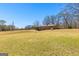 Spacious backyard featuring a well-manicured lawn, mature trees, and a charming home exterior at 461 Old Jackson Rd, Mcdonough, GA 30252