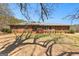 Charming brick ranch-style home with a well-maintained yard and mature landscaping under a clear blue sky at 461 Old Jackson Rd, Mcdonough, GA 30252