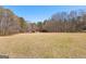 Two rustic barns located in the field with mature trees under a sunny sky at 461 Old Jackson Rd, Mcdonough, GA 30252