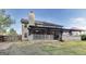 The backyard features a covered deck, mature trees and privacy fencing at 365 Othello Dr, Hampton, GA 30228