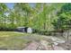 Large backyard with storage shed and mature trees creates a private oasis at 365 Othello Dr, Hampton, GA 30228