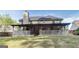 View of the spacious backyard with a covered back deck and mature trees at 365 Othello Dr, Hampton, GA 30228