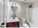 The well-lit bathroom features a single sink vanity, toilet, and shower-tub combo, designed for functionality at 365 Othello Dr, Hampton, GA 30228