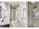 Bright bathroom features a double sink vanity, separate tub and shower, and neutral tile flooring at 365 Othello Dr, Hampton, GA 30228