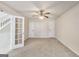 A spacious bedroom with neutral carpet and a door leads to the landing over the stairs at 365 Othello Dr, Hampton, GA 30228