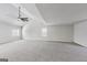 An oversized bonus room features vaulted ceilings, carpet, and natural light at 365 Othello Dr, Hampton, GA 30228