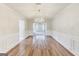 Formal dining room boasts hardwood floors, wainscoting, a chandelier, and a serene ambiance at 365 Othello Dr, Hampton, GA 30228