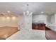 This dining room features a modern chandelier, tile flooring, and seamlessly connects with other living spaces at 365 Othello Dr, Hampton, GA 30228