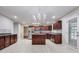 Updated kitchen with granite countertops, stainless steel appliances, dark cabinets, and a center island at 365 Othello Dr, Hampton, GA 30228