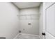 Laundry room with washer and dryer hookups and a wire shelf for storage at 365 Othello Dr, Hampton, GA 30228