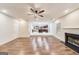 Open-concept living area with wood floors, fireplace, and a view to the stylish kitchen with island at 365 Othello Dr, Hampton, GA 30228