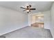 Cozy living room with neutral paint, plush carpet, a ceiling fan, and an open layout at 365 Othello Dr, Hampton, GA 30228