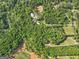 An aerial view showcasing a property surrounded by dense trees, offering a secluded and private environment at 2331 Hollonville Rd, Brooks, GA 30205