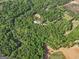 The aerial perspective displays a home site embraced by a forest, potentially offering a tranquil and nature-filled lifestyle at 2331 Hollonville Rd, Brooks, GA 30205