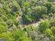 Scenic aerial view of a creek winding through a tranquil, wooded landscape at 2331 Hollonville Rd, Brooks, GA 30205