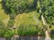 The aerial perspective showcases a rural property surrounded by trees, presenting an opportunity for peaceful, country living at 2331 Hollonville Rd, Brooks, GA 30205