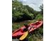 Tranquil river view with a kayak resting on the grassy bank at 2331 Hollonville Rd, Brooks, GA 30205