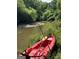 Calm river with lush green trees, plus a kayak and fishing pole at 2331 Hollonville Rd, Brooks, GA 30205