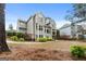 A spacious backyard with a grey two-story house in the background, bordered by a fence and landscaping at 216 Southwick Ln, Peachtree City, GA 30269