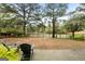 Relaxing backyard view with patio seating overlooking a serene lake surrounded by mature trees at 216 Southwick Ln, Peachtree City, GA 30269