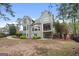 Spacious backyard features a patio with seating, a partial deck and lush landscaping surrounding the home at 216 Southwick Ln, Peachtree City, GA 30269