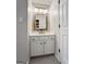 Bathroom with a white vanity, framed mirror, and a neutral color palette at 216 Southwick Ln, Peachtree City, GA 30269