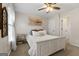Inviting bedroom featuring a white bed, ceiling fan, and an adjacent doorway at 216 Southwick Ln, Peachtree City, GA 30269