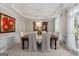 Elegant dining room with a classic chandelier, wainscoting, and large windows for natural light at 216 Southwick Ln, Peachtree City, GA 30269