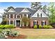 Charming brick two-story home with well-manicured landscaping and a welcoming front entrance at 216 Southwick Ln, Peachtree City, GA 30269