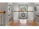 Well-lit hallway with a large window, chandelier, and hardwood floors at 216 Southwick Ln, Peachtree City, GA 30269
