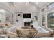 Cozy living room featuring built-in shelving, fireplace, and scenic backyard views at 216 Southwick Ln, Peachtree City, GA 30269