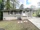 Backyard view of a charming single-story home with fresh exterior paint and mature trees at 1994 Marvin Sw Ln, Atlanta, GA 30311