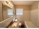 Bright bathroom with updated vanity, white tile, and natural light from the window at 1994 Marvin Sw Ln, Atlanta, GA 30311