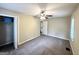 Bedroom with neutral walls, carpeted floor, ceiling fan, and natural lighting at 1994 Marvin Sw Ln, Atlanta, GA 30311