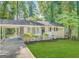 Charming one-story home featuring a carport, well-maintained lawn, and mature trees at 1994 Marvin Sw Ln, Atlanta, GA 30311