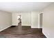 Spacious living room features vinyl flooring, neutral paint, and access to other rooms at 1994 Marvin Sw Ln, Atlanta, GA 30311