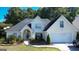 Charming two-story home featuring a manicured lawn and a convenient two-car garage at 200 Kensington Trce, Stockbridge, GA 30281