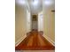Long hallway featuring beautiful hardwood floors and neutral colored walls at 200 Kensington Trce, Stockbridge, GA 30281