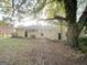 Expansive backyard featuring a patio area, lush lawn, and mature trees, creating a private outdoor retreat at 2099 Yucca Dr, Decatur, GA 30032