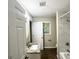 Well-lit bathroom with tile shower, granite counters, and round mirror over a pedestal sink at 2099 Yucca Dr, Decatur, GA 30032