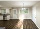 Eat-in kitchen boasts stainless appliances, granite countertops, and a dining area with a modern chandelier and lots of natural light at 2099 Yucca Dr, Decatur, GA 30032