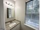 Bright bathroom featuring granite counters, a window, and modern lighting at 2578 Lavender Ct, Decatur, GA 30034