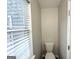 Clean toilet beside a window in a simple, bright bathroom at 2578 Lavender Ct, Decatur, GA 30034