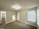 A cozy bedroom featuring neutral paint, carpeted flooring, and bright windows for comfortable living at 2578 Lavender Ct, Decatur, GA 30034
